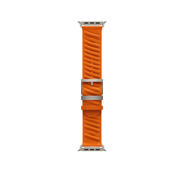 Orange 49mm Hermès En Mer Apple Watch band laid flat, showing the patterned fabric, titanium buckle and adjustment holes.