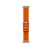 Orange 49mm Hermès En Mer Apple Watch band laid flat, showing the patterned fabric, titanium buckle and adjustment holes.