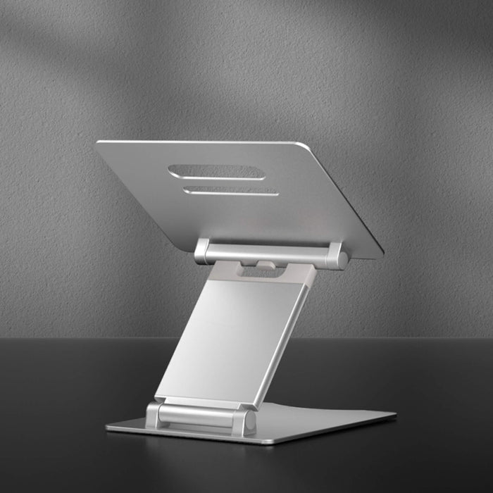 Portable silver laptop stand with adjustable height, shown with a laptop, available at TaMiMi Projects in Qatar.
